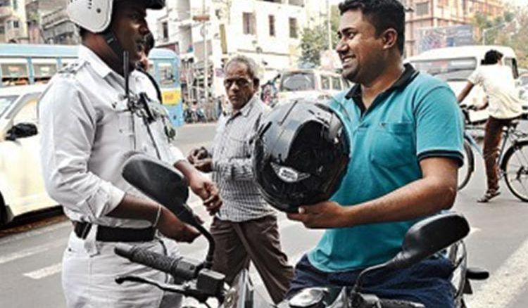 Bikers without helmet fined 100 Rs. provided a helmet for free